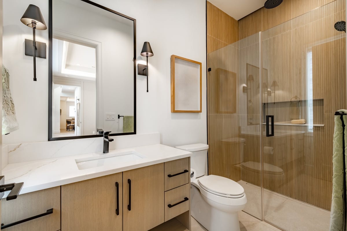 Vernon Hills, IL primary bathroom remodel by Century Kitchens & Bath featuring walk-in shower and double Bertch vanity