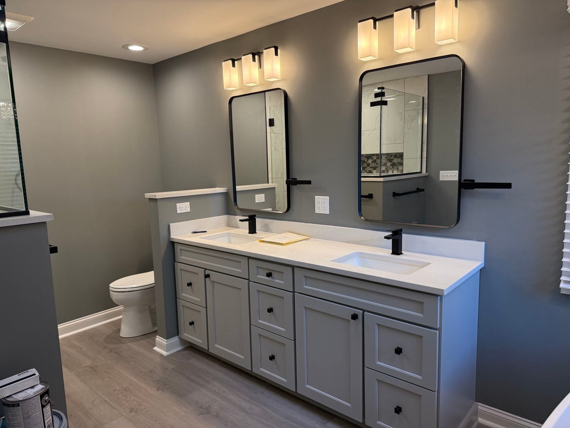 Custom primary bathroom remodel in Libertyville, IL by Century Kitchens & Bath featuring walk-in shower, freestanding tub, and double Bertch vanity