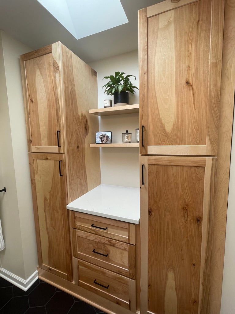 Wooden closet space with natural light from skylight, featuring shelving, drawers, and decorative items